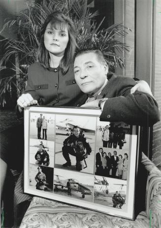 Always in mind: Elena Calderon, sister of Canada's Emile Calderon who is flying in the gulf, and her father Emilio show off a photo collage they put together at Christmas