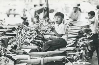 This boy is sidewalk parking bike Attendent