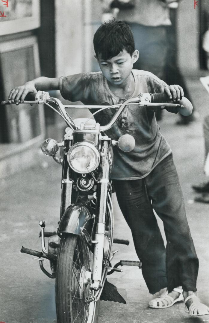Boy with a motorbike, Honda is still symbol of capitalist good life