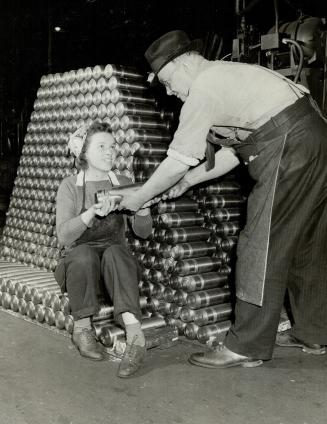 Father and daughter work side by side at adjoining machines in the shell plant