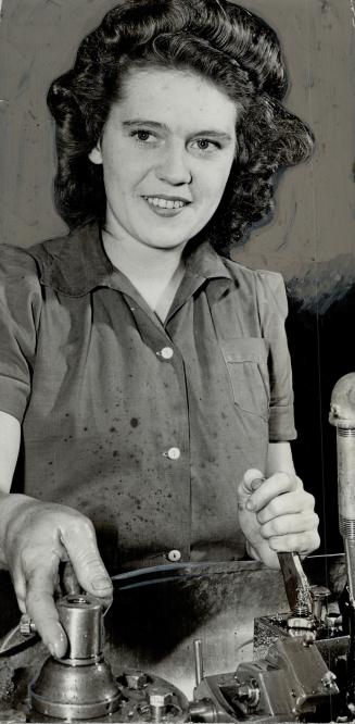 Operating a milling machine, Jean McRae, Newton-brook, is one of the few single girls working in the plant