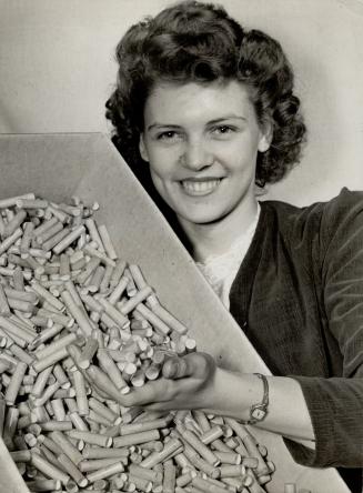 War worker Jane Cox holds a carton of finished paper components for shells, ready to be shipped to a shell Plant