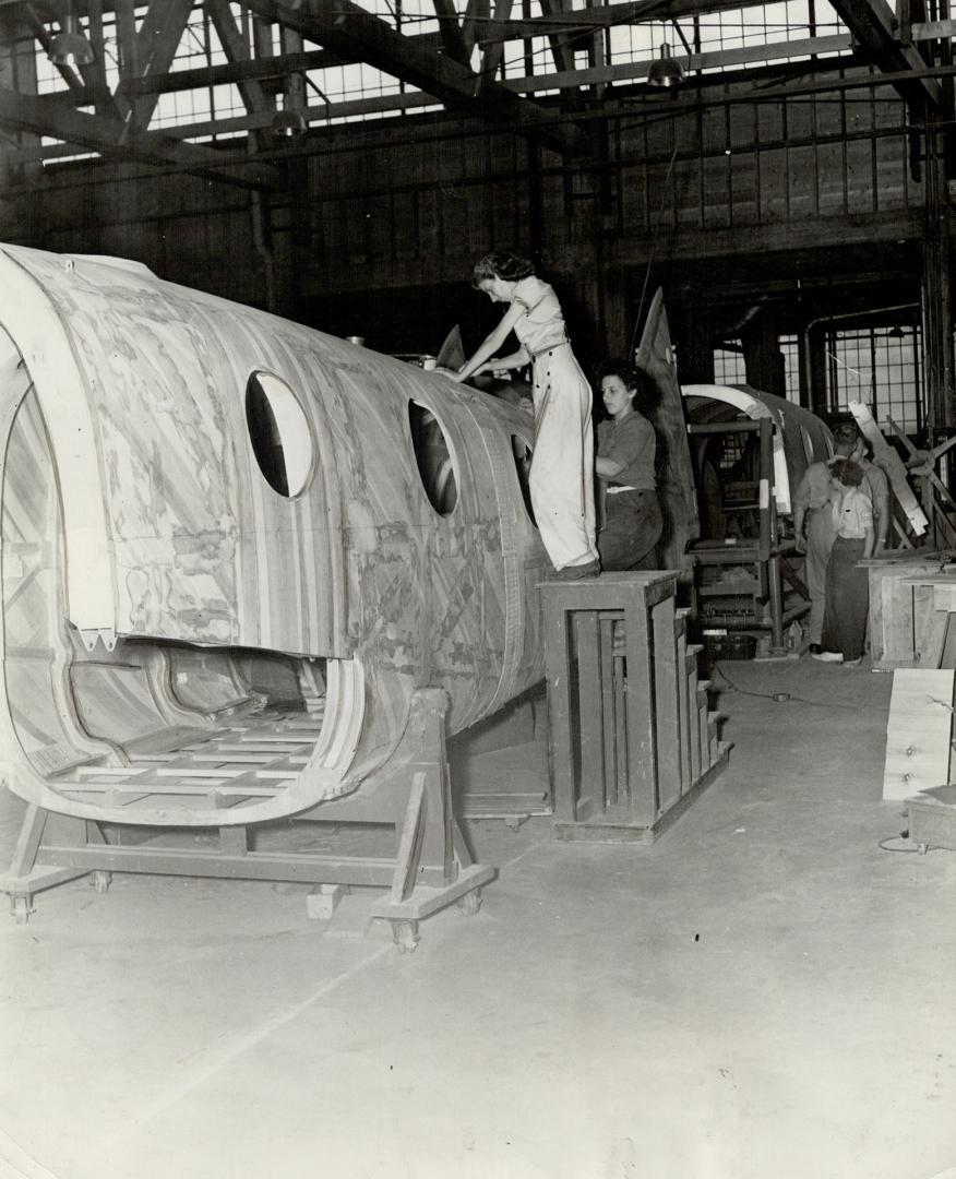 Final touches are applied to a completed fuselage