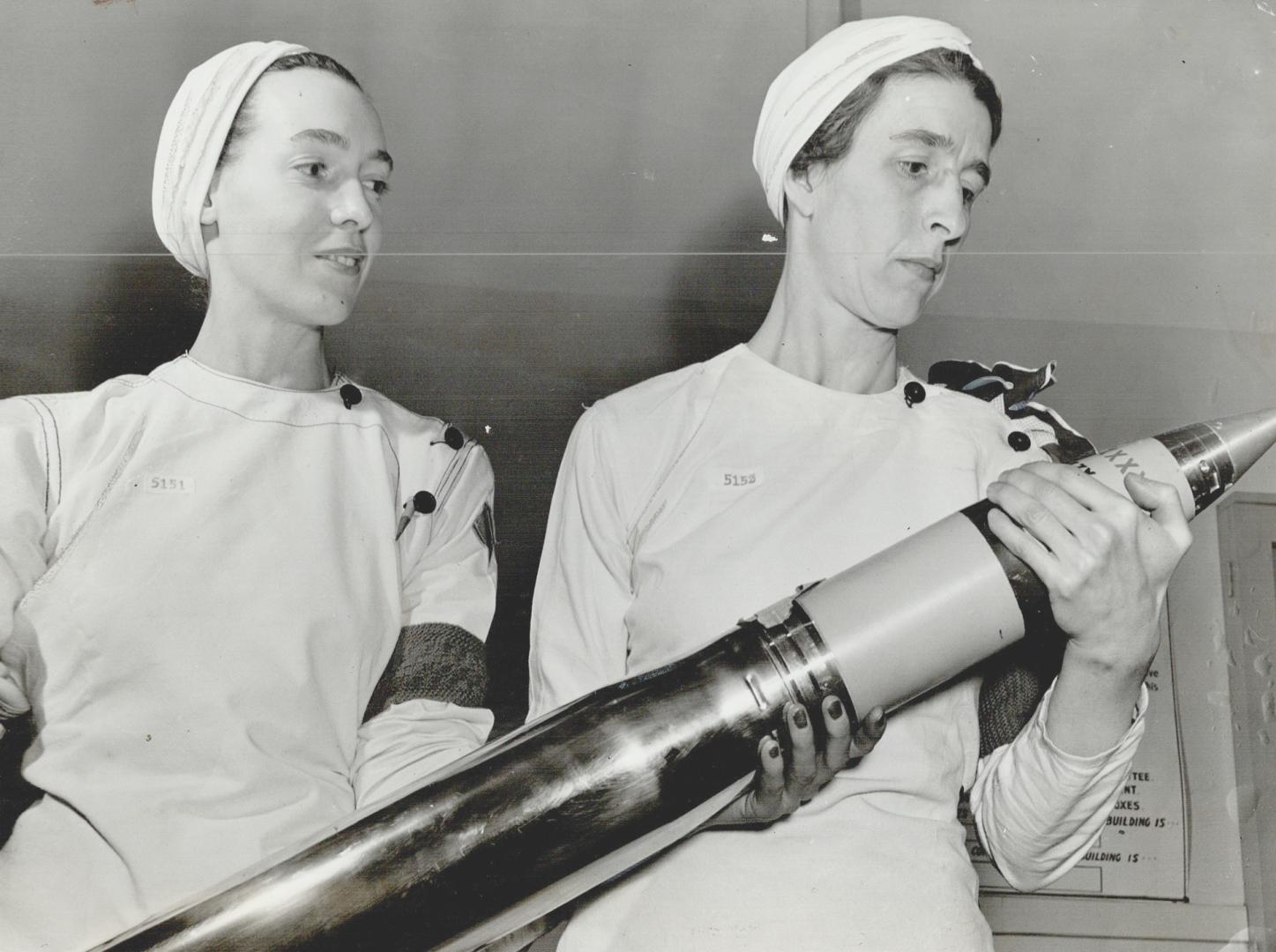 ''The Stewart Girls'' as they are known at the plant, look over a shell which they helped make
