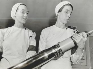 ''The Stewart Girls'' as they are known at the plant, look over a shell which they helped make