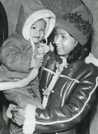 Lam My Ngai, 2, clings to her mother, Van Tieu Lien, after arriving in Toronto