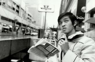 Going by the book: Chi Cuong, an 18-year-old from Viet Nam gets from point A to point B with the aid of class around town