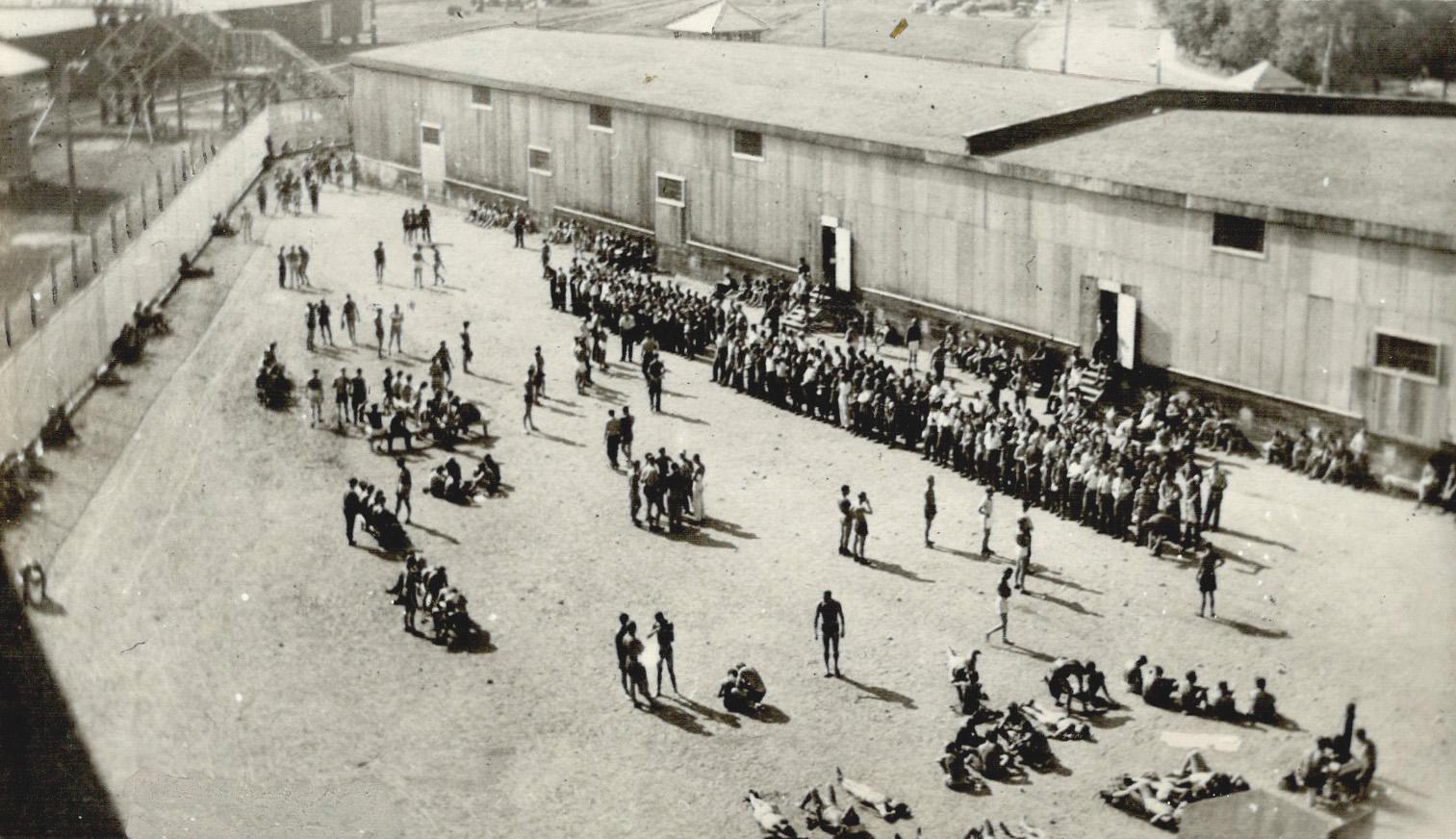 Left behind, A crowd of German prisoners lounge about the yard of a prison camp in the Sudbury area, from which an airman and a naval petty officer es(...)