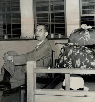Big Fish in the Allied war crime net, Nobosuke Kishi, Japanese cabinet member ime of Pearl Harbor, sits with his belongings awaiting removal from his jail cell [Incomplete]