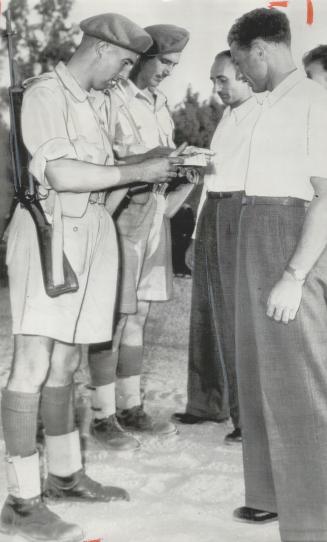 Tension again runs high in Palestine where these Welsh guardsmen check identity cards of Jews at a road block near Nathanya where two British sergeants were kidnapped