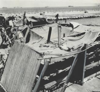 Burlap bags and rags make up the bedding of these crude bunks for six persons, sleeping quarters for Jewish refugees on board the ships which brought them to Haifa where they were held by the British