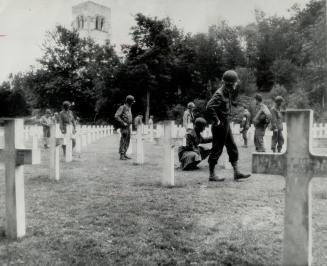 Belleau Wood where American troops in the last war made an historic attack, is visited by soldiers of this war who look for the names of relatives and friends in the cemetery