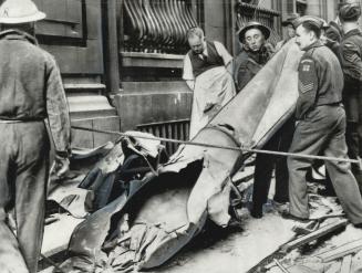 Home guard and R.A.F. men remove the casing of a German flying bomb which crashed and exploded in the Regent Palace hotel annex in London. The hotel s(...)