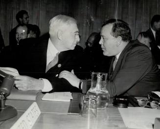 Conferring during the first session of the United Nations atomic energy commission are Bernard M
