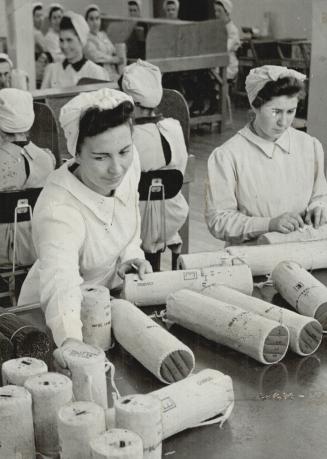 Handle With Care is the motto of the girls as they pack cordite is silk bags in a munitions plant