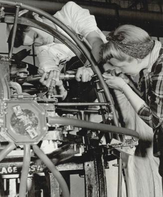 Revolutionary! exclaimed a supervisor, at women working on parts of fuselage, as Valida igle and Jean Neil are, rivetting main piping [Incomplete]