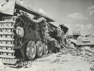 Time did not destroy this engine of death, an Axis tank, whose mangled remains strew the desert sands of North Africia, silent testimony to the fall of Italy's empire