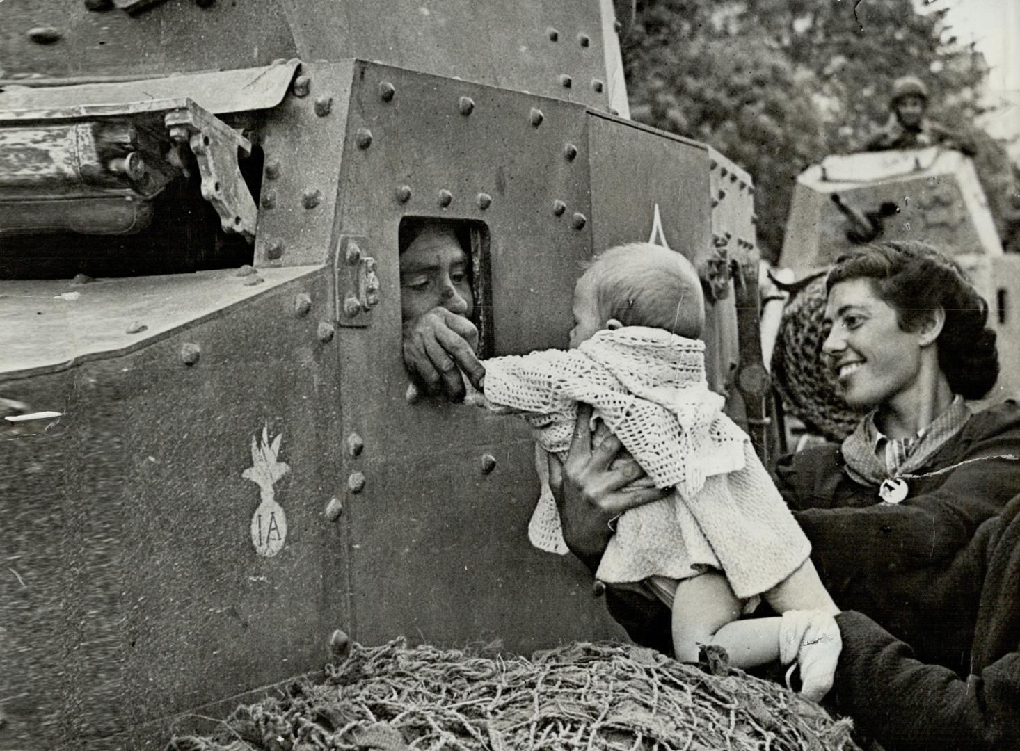 Welcome To Tunis, is the cry of this woman and her small baby to the driver of a French reconnaissance car as the men of the Zouave regiment accept th(...)
