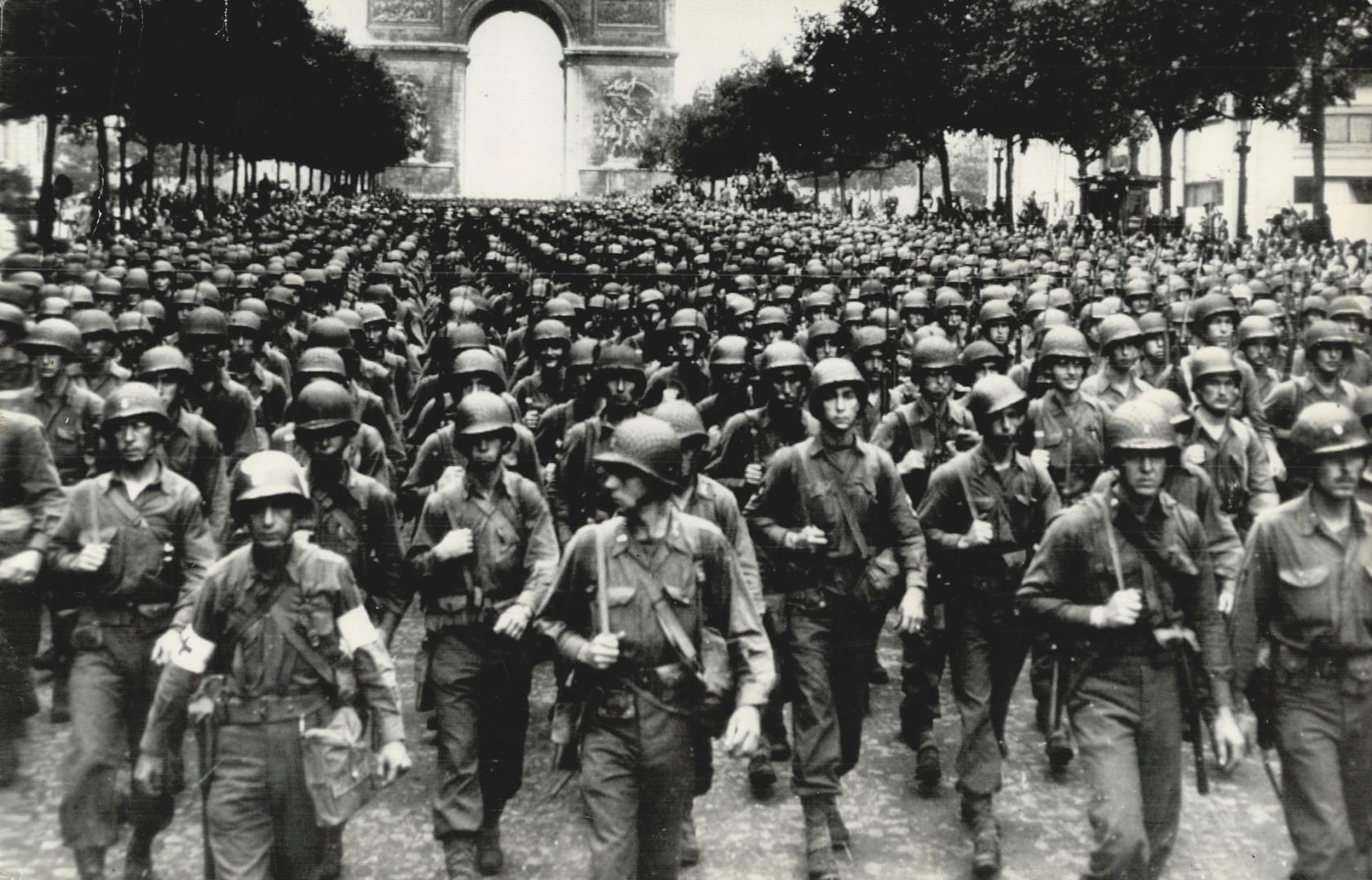A great column of U.S. troops swings down the famous Champs Elysees, under the Arc de Triomphe, in Paris, during the victory parade held after the Fre(...)