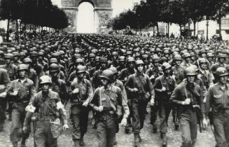A great column of U.S. troops swings down the famous Champs Elysees, under the Arc de Triomphe, in Paris, during the victory parade held after the Fre(...)