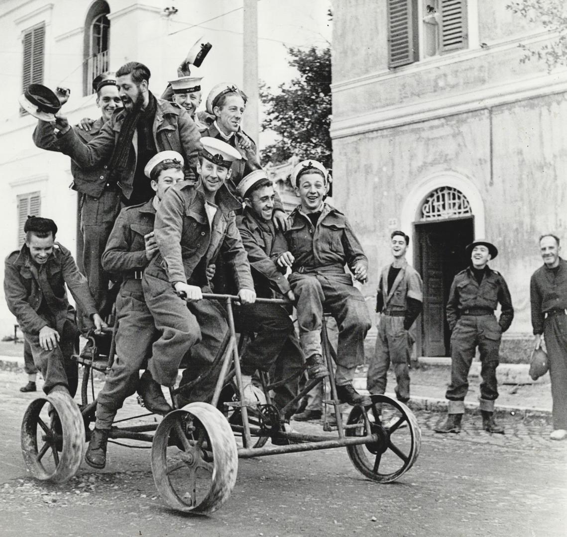 Handcar from a railroad is the vehicle these sailors for a jaunt through the streets of an Italian town, to prove they are in possession of their land legs. [Incomplete]