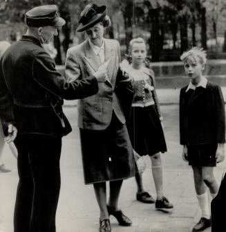 Prison pass is displayed by Frau Frick, wife of Wilhelm Frick, former Nazi minister of the interior, as she enters Nuremberg prison with her two child(...)