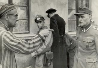 Russian slave laborer here points out a former German guard, right, who beat prisoners in the Nazi camp