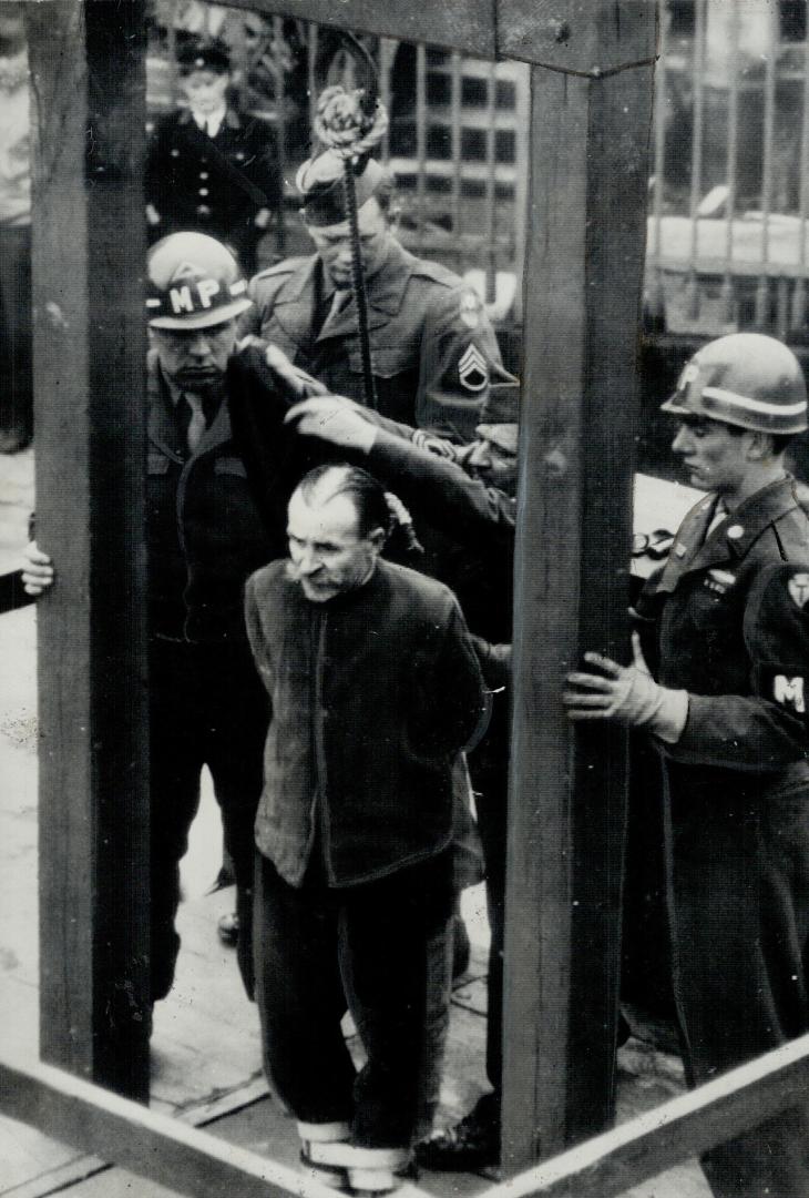 Another German, of the five executed for the same crime, hears the order for his hanging read by U
