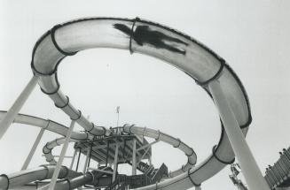 Above, a bather whips through a water slide at wild water Kingdom on Finch Ave