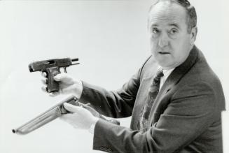 Det. Paul Mullin w/sawed-off shotgun and a pistol
