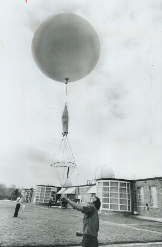 Floyd Clark releases balloons, It will radio back the weather at 100,000 feet