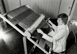 Master Weaver: Margareta Ljungberg works at new loom that takes only 10 minutes to thread and has pattern design cylinders