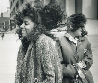 Hair-raising: Winnipeg's portage and main is famed for high winds, but Dawn Ward (left) and Arlene Samsalsingh found Bloor and Yonge equally bad yesterday