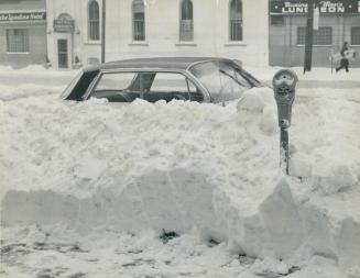 Wait for spring might be good advice for the owner of this car, surrounded by window-high snow at Spadina Ave