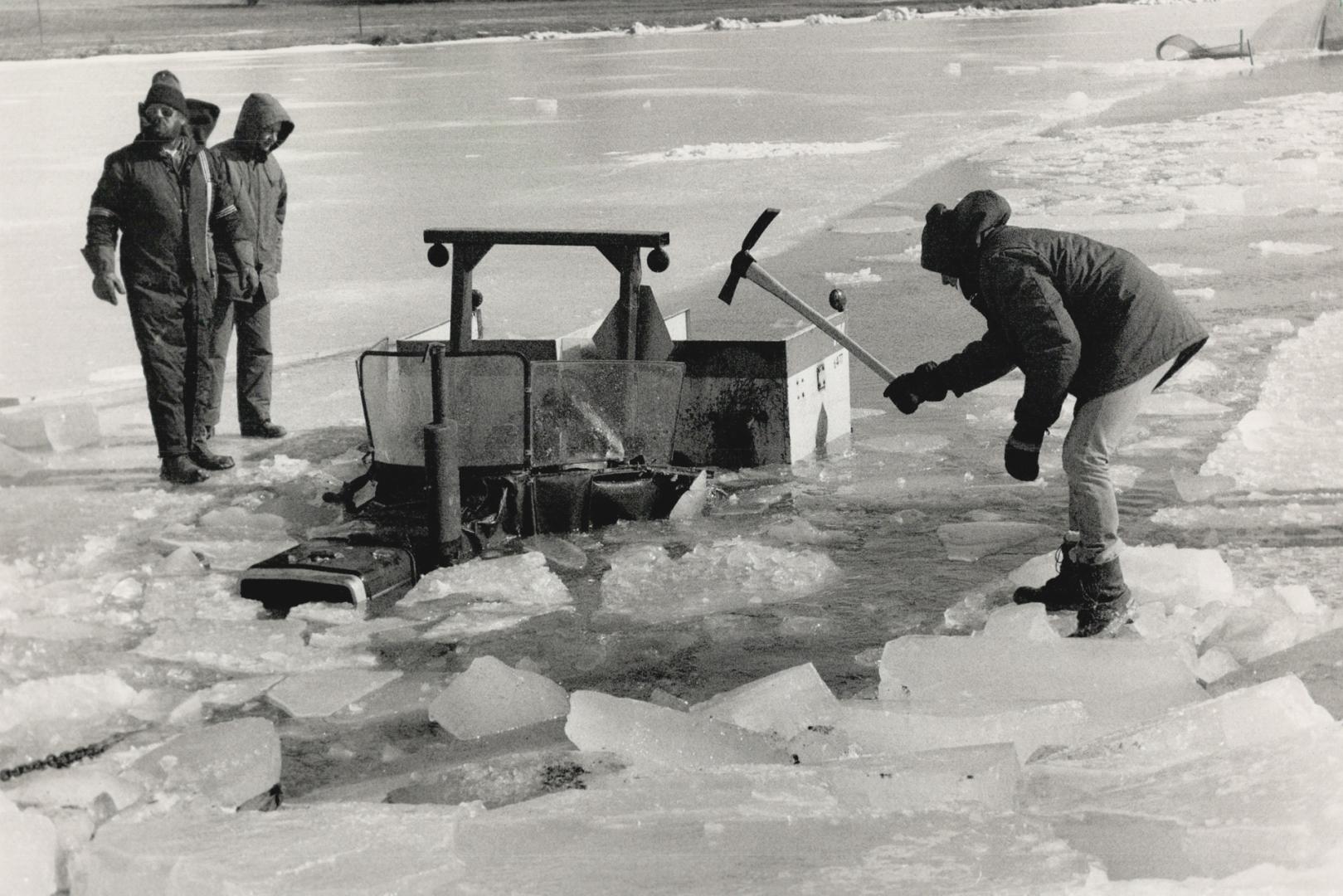 That sinking feeling, An employee of Etobicoke's parks and recreation department hacks away at ice around an ice-cleaning tractor
