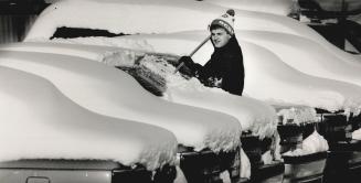 This job's snow fun, Orillia car lot employee Mike Bennett Donaldson got swept up in his work yesterday trying to clear away the 25 centimetres (10 inches) of snow that fell overnight
