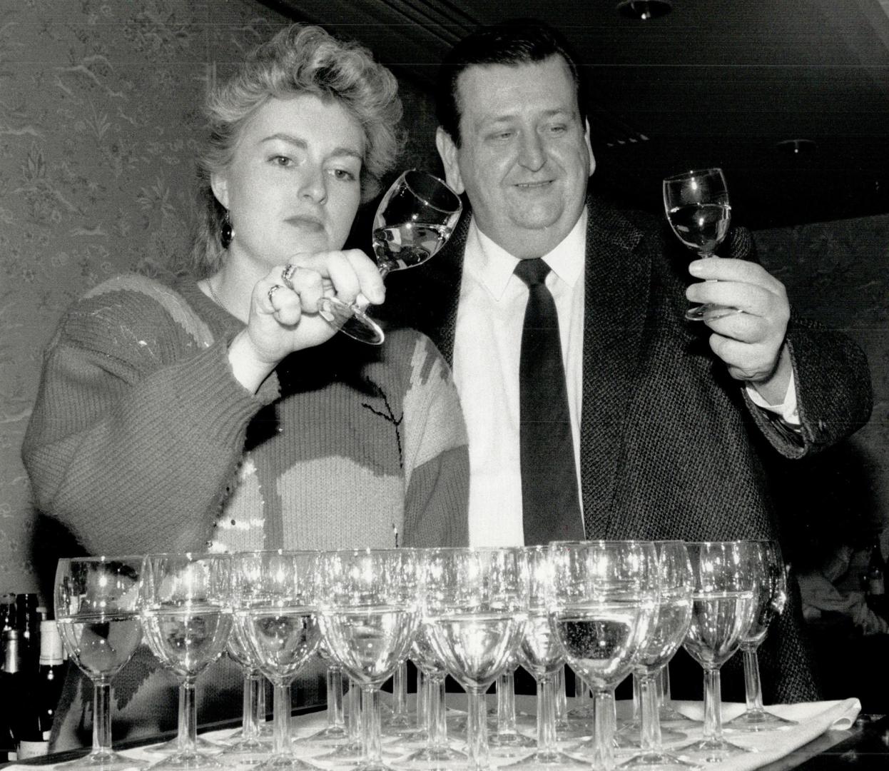 Tough task: Shari Mogk-Edwards of the Liquor Control Board of Ontario and Andrew Sharp check two of the thousands of glasses of wine at what's billed as North America's top wine contest