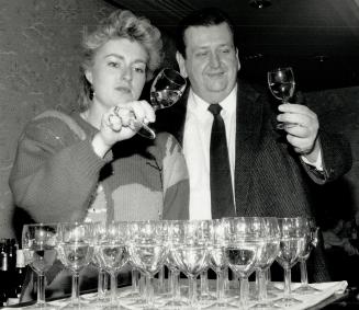Tough task: Shari Mogk-Edwards of the Liquor Control Board of Ontario and Andrew Sharp check two of the thousands of glasses of wine at what's billed as North America's top wine contest