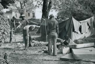 Folding their tent, some of the last 70 residents Wacheea, the tent city on the grounds of the old Mercer Reformatory, prepare to move out yesterday o(...)