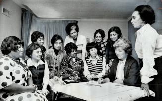 Getting involved in the planning and excitement of International Women's Year, women from various racial minorities met in Metro at the home of Kay Li(...)
