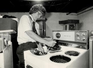 Barbara Elend fixes a stove at Karl's Appliance Service