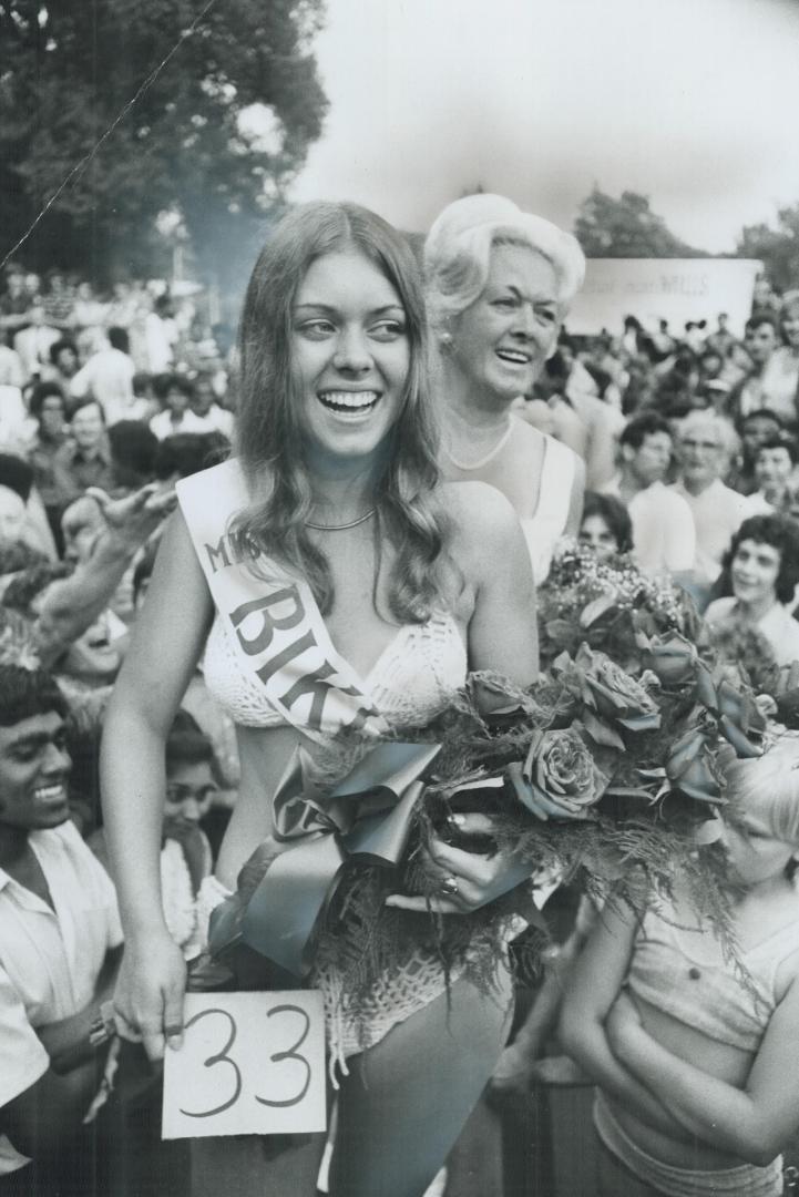 Picked as miss bikini for obvious reasons, 16-year-old Heidi Willi holds bouquet of flowers yesterday at fifth annual International Picnic at Toronto Islands