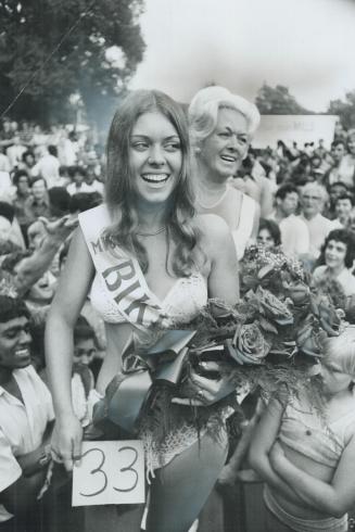 Picked as miss bikini for obvious reasons, 16-year-old Heidi Willi holds bouquet of flowers yesterday at fifth annual International Picnic at Toronto (...)