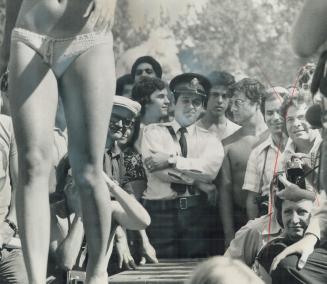 Miss Bikini contestants parade along a runway, making their turns right where Constable Maurice Biancolin was on duty at International Picnic. At one (...)