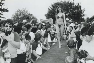 Miss Bikini: Eva Domik takes centre stage at the Chin-Moison international Picnic at Exhibition Place yesterday after winning the Miss Chin Bikini contest over 19 other entrants