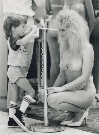 Pint-size pep talk, Chad Adams, 4, has a last-minute chat with his sister, Tanya Vonk, before she is judged yesterday at the Miss Canada Day bikini co(...)