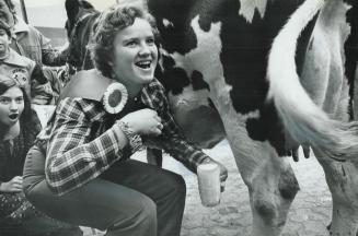 Milkmaid, Cheryl Anne West of Lakeside - Miss Oxford County - showed her prowess in the ancient art of milking cows as part of the Ontario Farmer's Da(...)