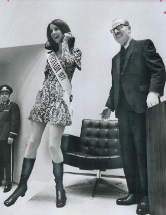 Miss Canada meets the Mayor, Wearing a mini-skirt, this year's Miss Canada, Carol Commisso, 18, stands beside Toronto Mayor William Dennison at City Hall yesterday