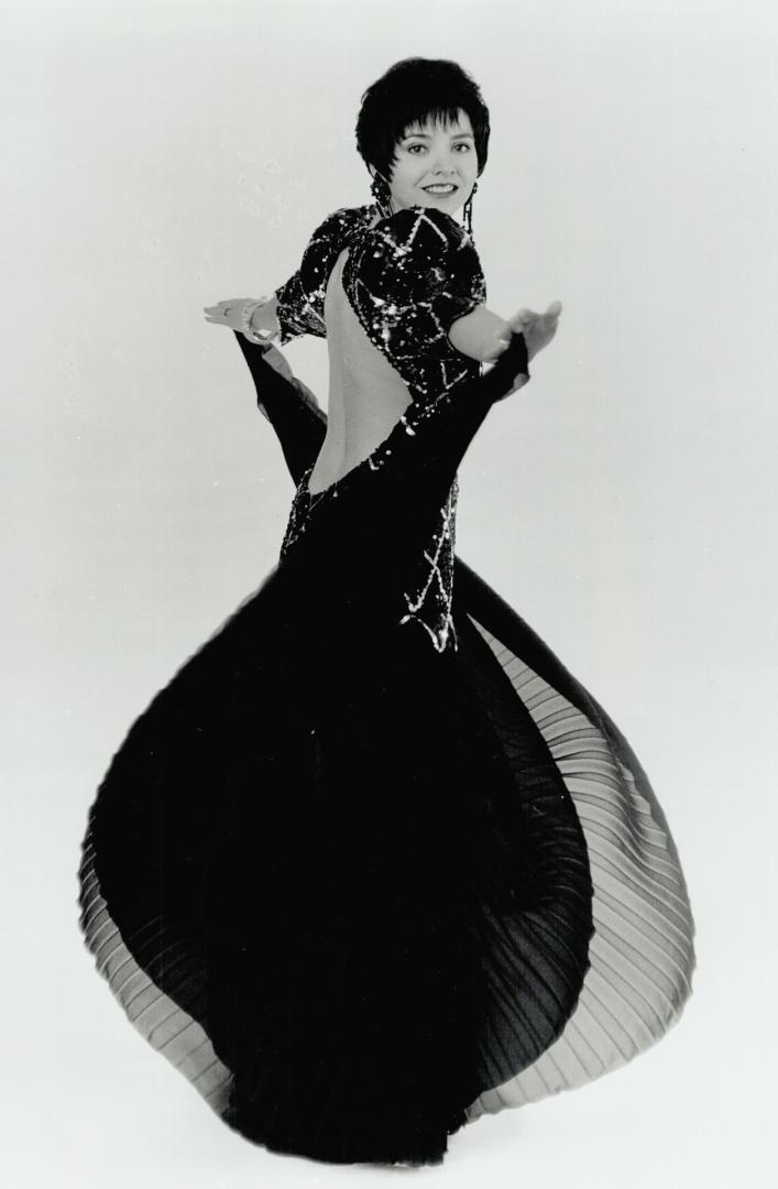 The $6,500 gown, Twelve metres of black georgette and 11 pennies to weight the bodice's sequinned peaks are among the ingredients of the gown, designe(...)