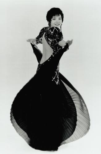 The $6,500 gown, Twelve metres of black georgette and 11 pennies to weight the bodice's sequinned peaks are among the ingredients of the gown, designe(...)